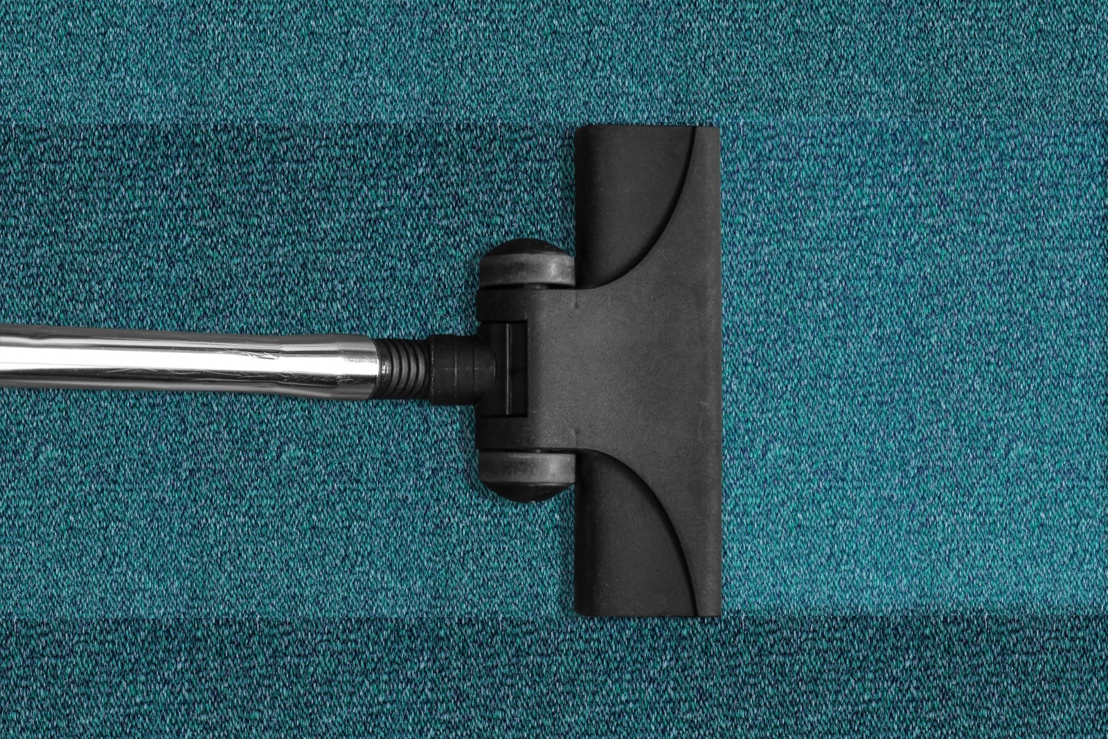 A vacuum cleaner on a blue rug
