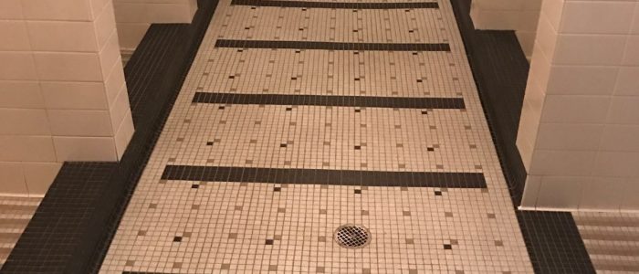 Black and white tile floor in a public restroom