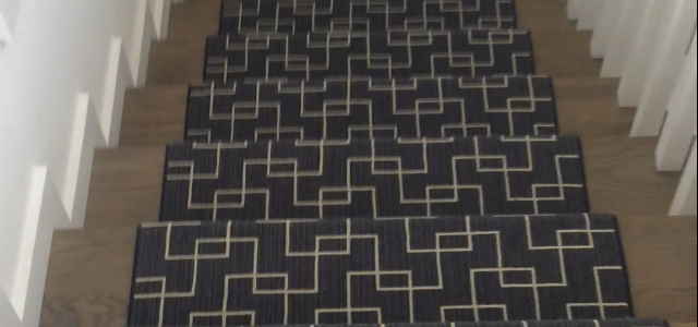 Carpet with a geometric pattern on wooden stairs